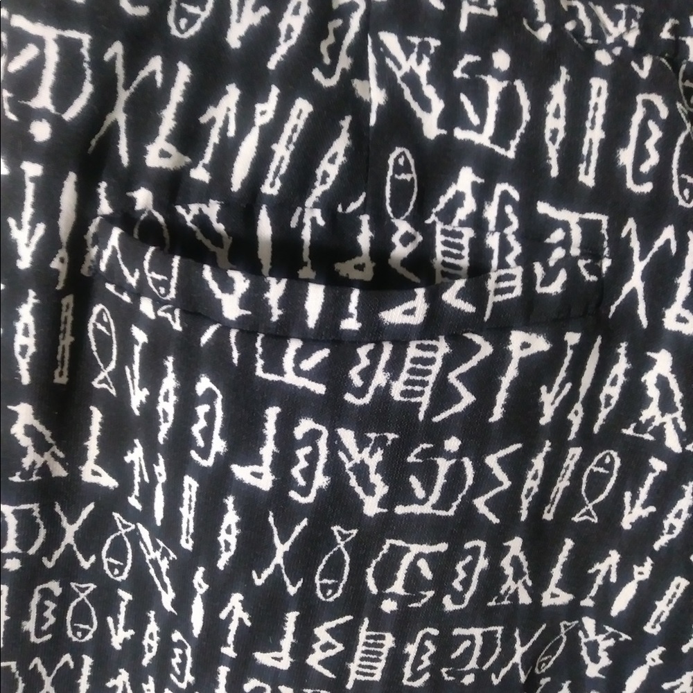 Black pants with Egyptian motifs.